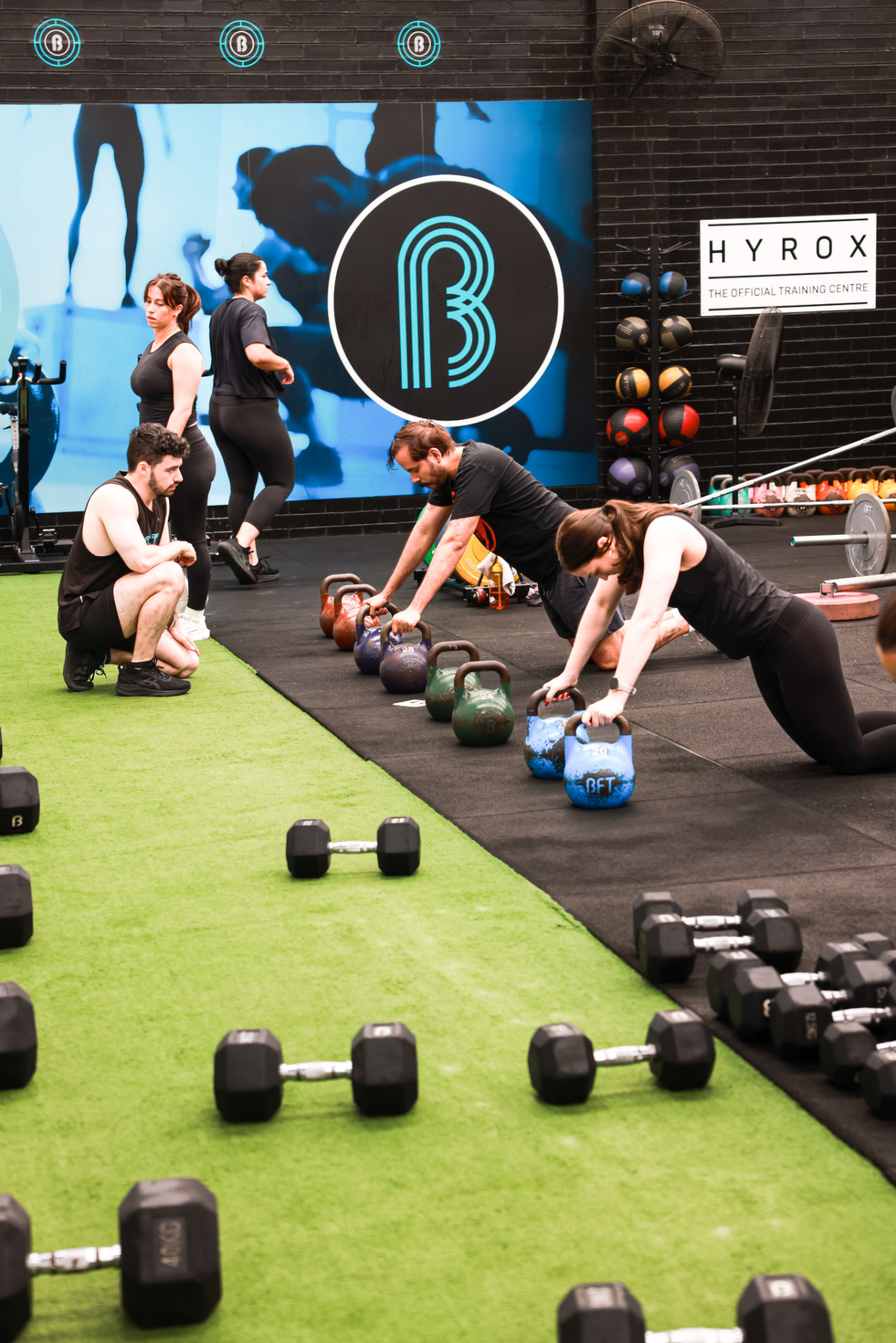 Members working through a coached kettlebell station at BFT Abbotsford